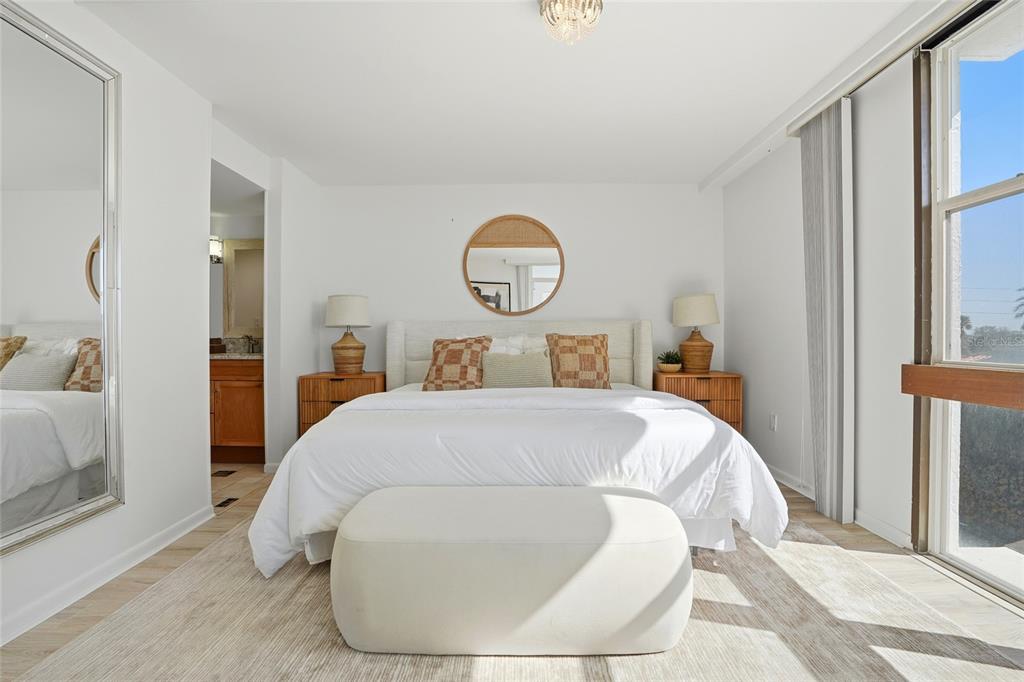 16308 Gulf Boulevard, Unit 303 Redington Beach, FL 33708 - Photo 25 of 42 a bedroom with a bed and a potted plant