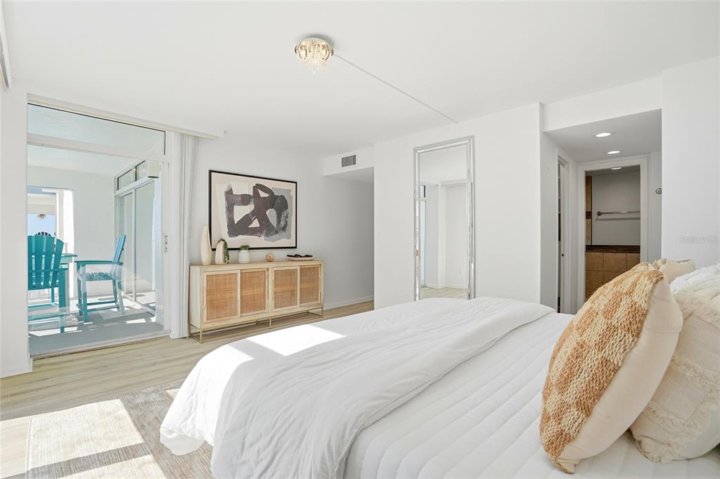 16308 Gulf Boulevard, Unit 303 Redington Beach, FL 33708 - Photo 26 of 42 a bedroom with a bed and a mirror