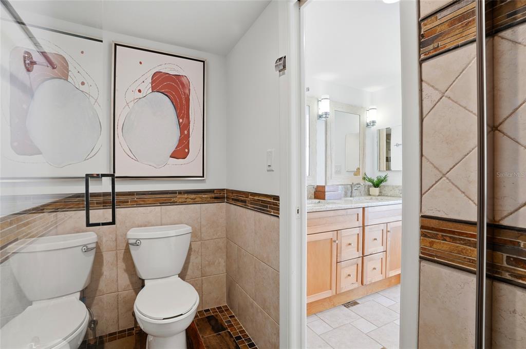 16308 Gulf Boulevard, Unit 303 Redington Beach, FL 33708 - Photo 29 of 42 a white toilet sitting next to a bathroom sink