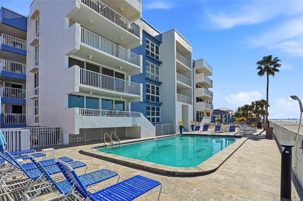 16308 Gulf Boulevard, Unit 303 Redington Beach, FL 33708 - Photo 38 of 42 a view of a swimming pool with a lounge chairs