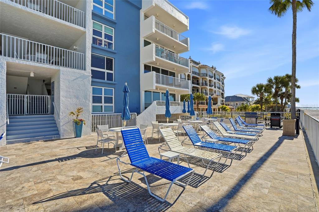16308 Gulf Boulevard, Unit 303 Redington Beach, FL 33708 - Photo 39 of 42 a view of a swimming pool with a lounge chairs