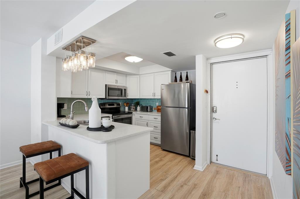 16308 Gulf Boulevard, Unit 303 Redington Beach, FL 33708 - Photo 6 of 42 a kitchen with refrigerator and cabinets