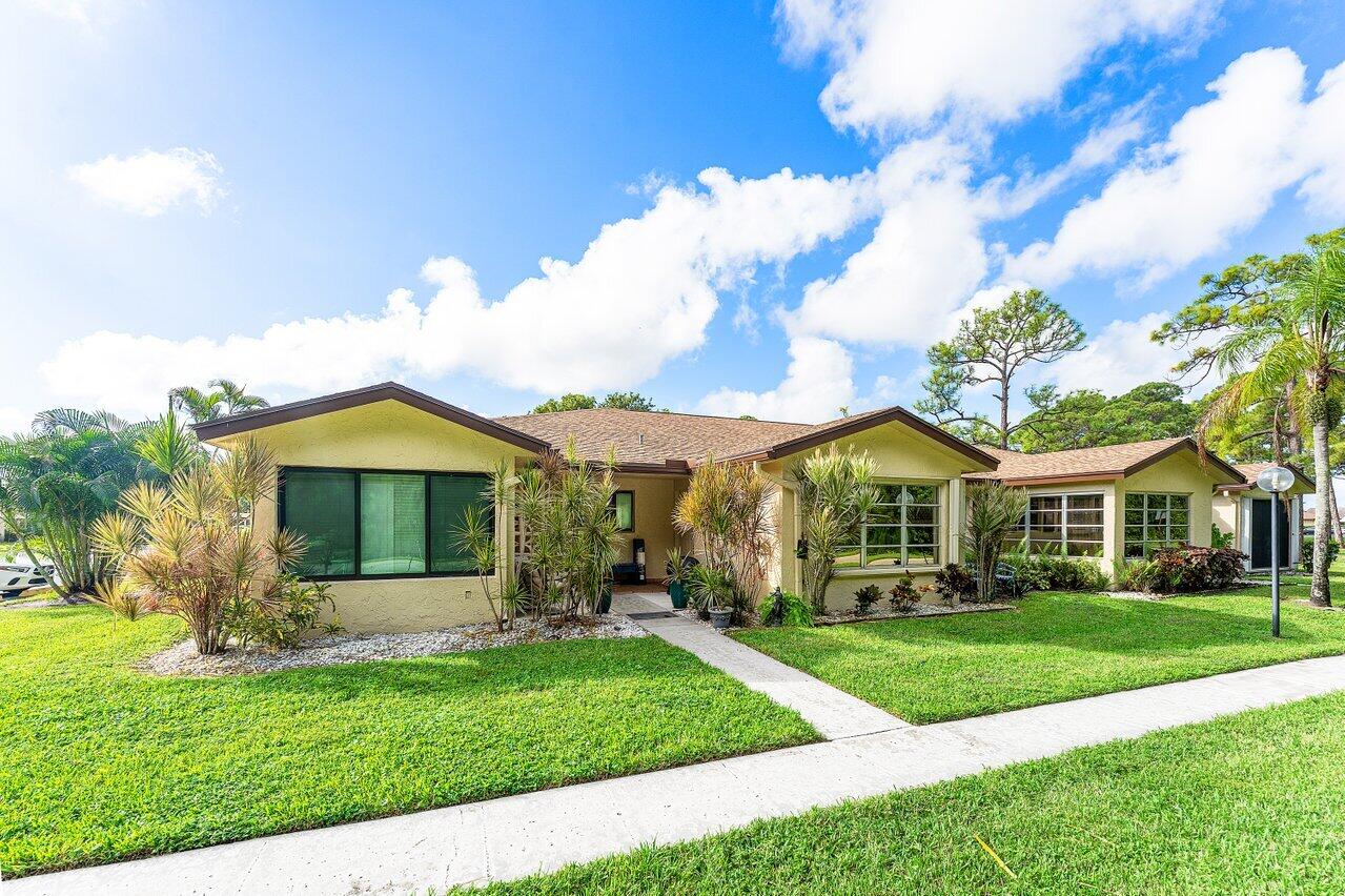 5300 Nesting Way, Unit A Delray Beach, FL 33484 - Photo 1 of 53 a front view of house with yard and green space