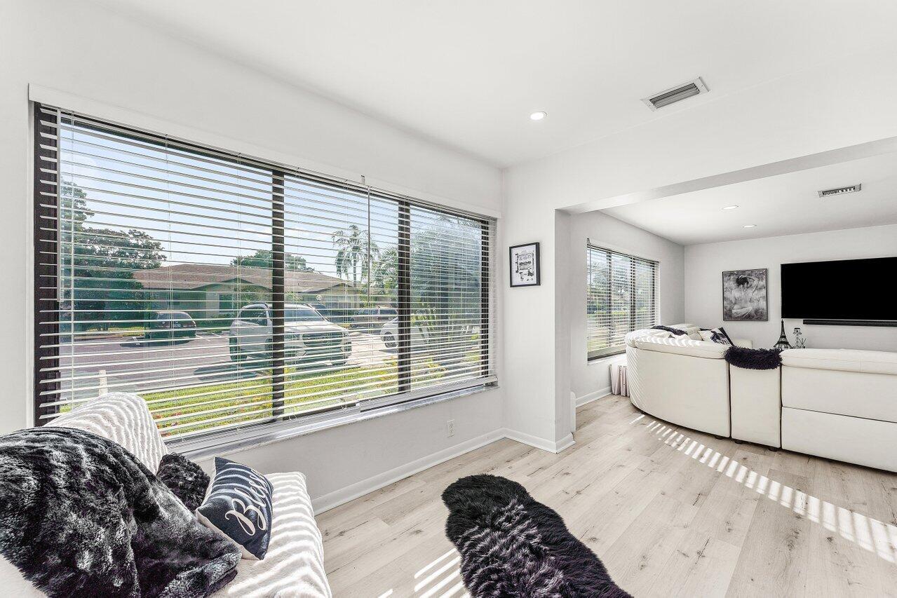 5300 Nesting Way, Unit A Delray Beach, FL 33484 - Photo 11 of 53 a bedroom with a bed and a television