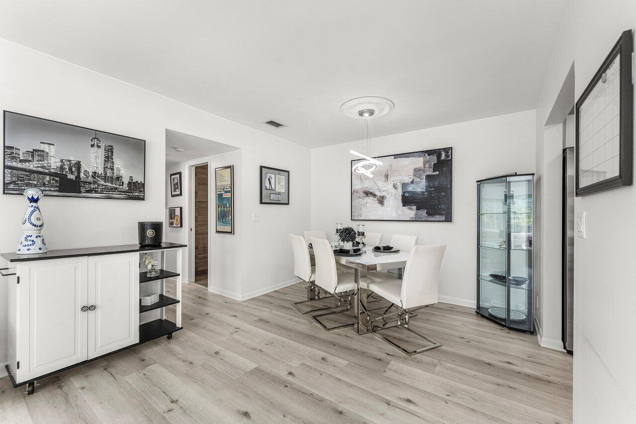 5300 Nesting Way, Unit A Delray Beach, FL 33484 - Photo 12 of 53 a view of a living room a dining room wooden floor and a window