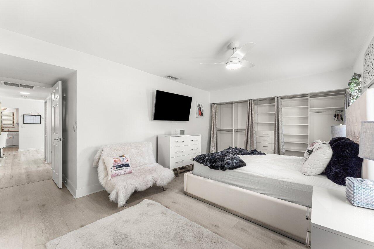 5300 Nesting Way, Unit A Delray Beach, FL 33484 - Photo 15 of 53 a bedroom with a bed a flat screen tv and a couch