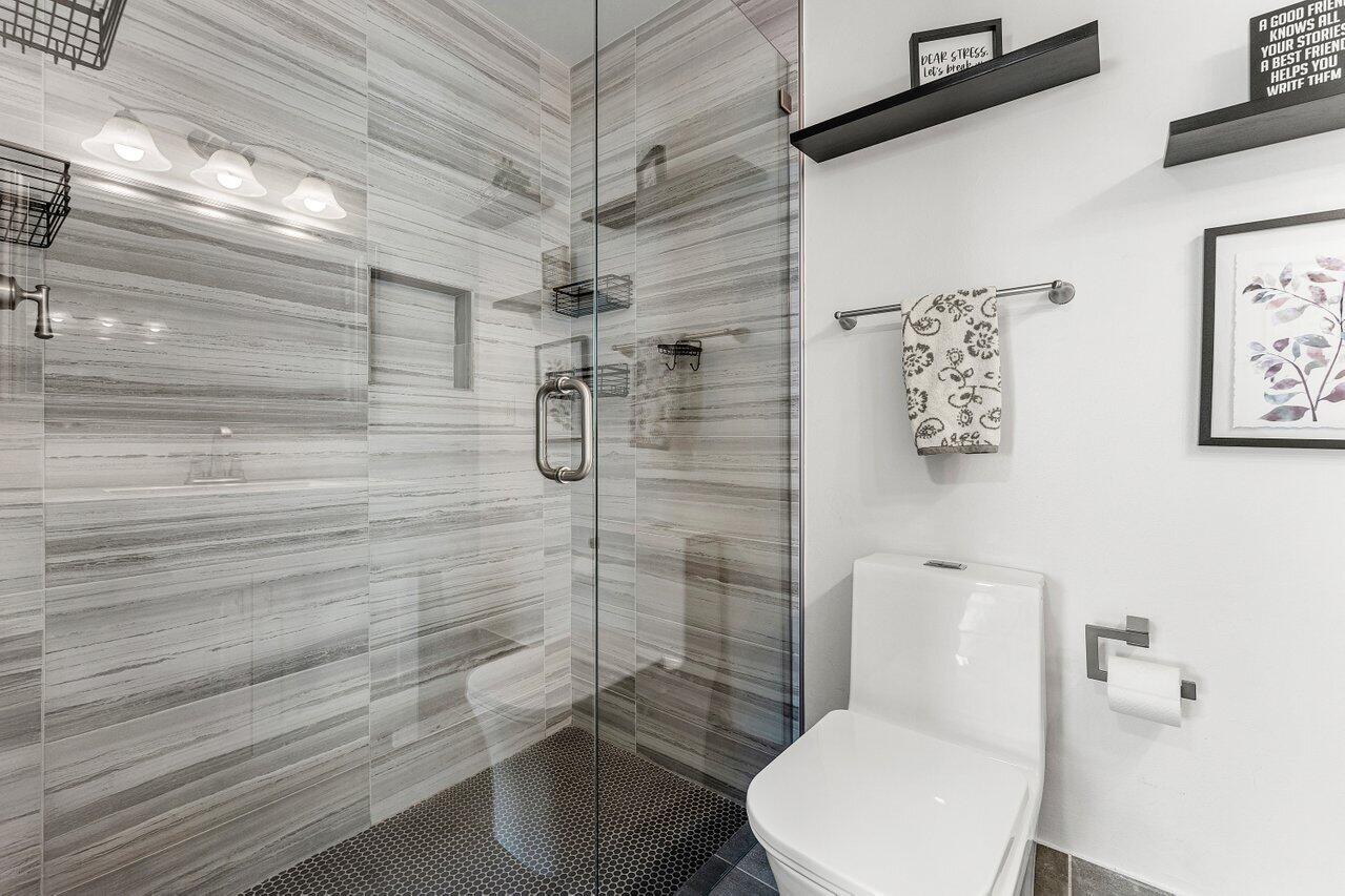 5300 Nesting Way, Unit A Delray Beach, FL 33484 - Photo 17 of 53 a bathroom with a toilet and shower
