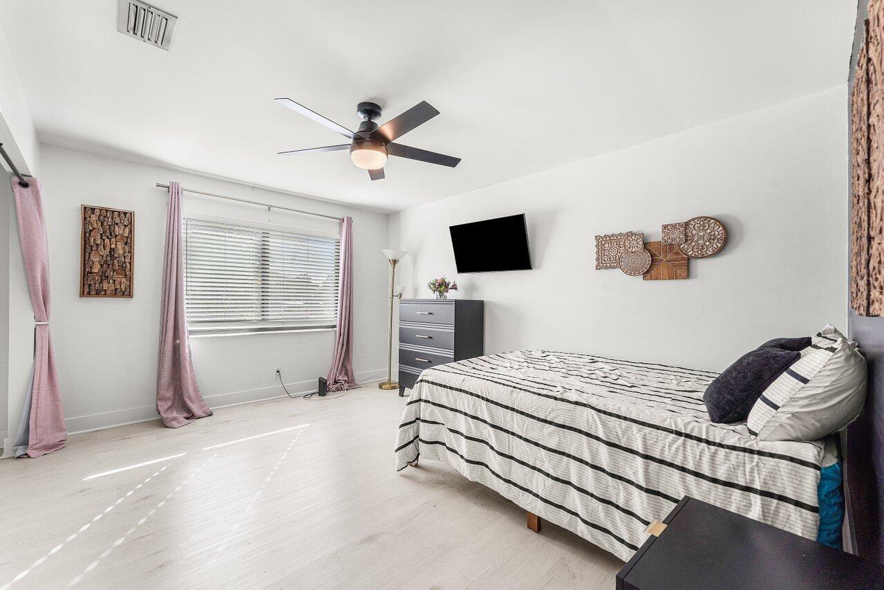 5300 Nesting Way, Unit A Delray Beach, FL 33484 - Photo 19 of 53 a bedroom with a bed and a window