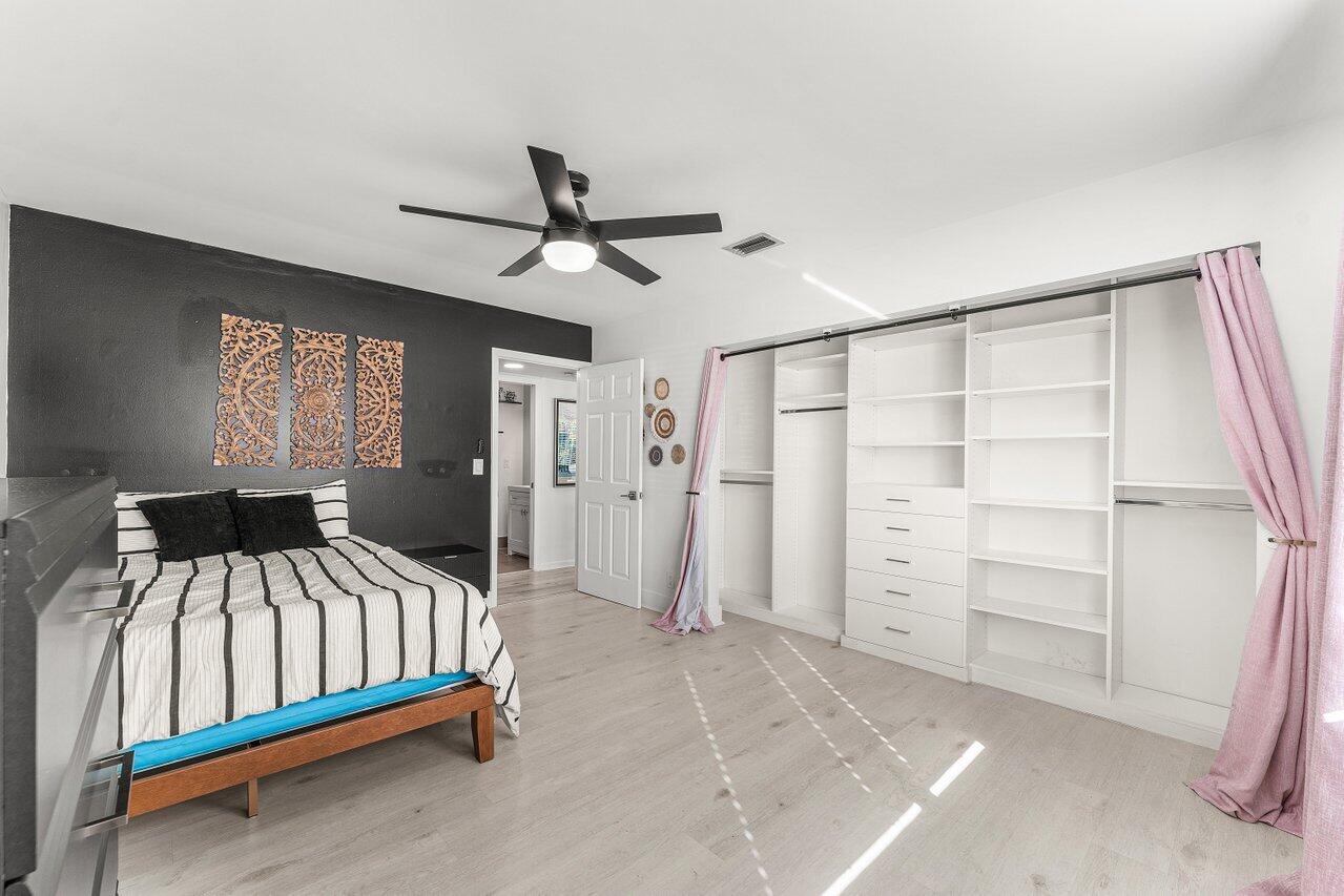 5300 Nesting Way, Unit A Delray Beach, FL 33484 - Photo 20 of 53 a bedroom with a bed and a walk in closet