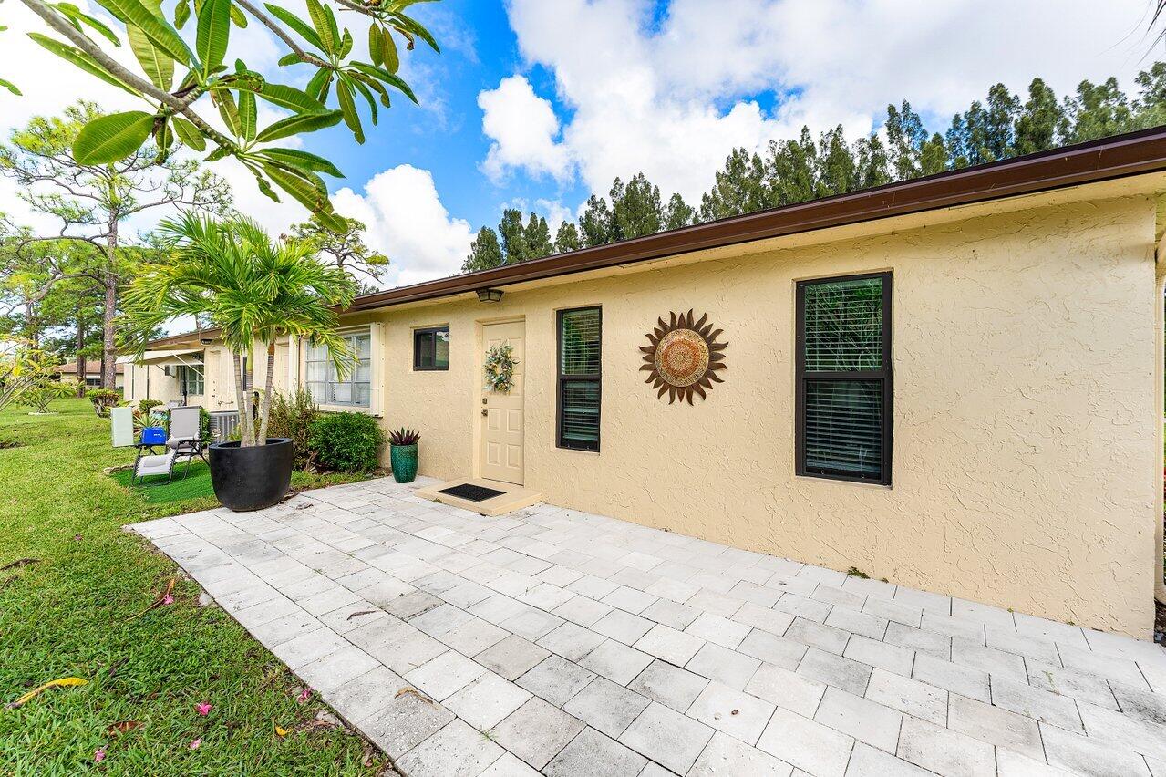 5300 Nesting Way, Unit A Delray Beach, FL 33484 - Photo 27 of 53 a view of a white house with a yard