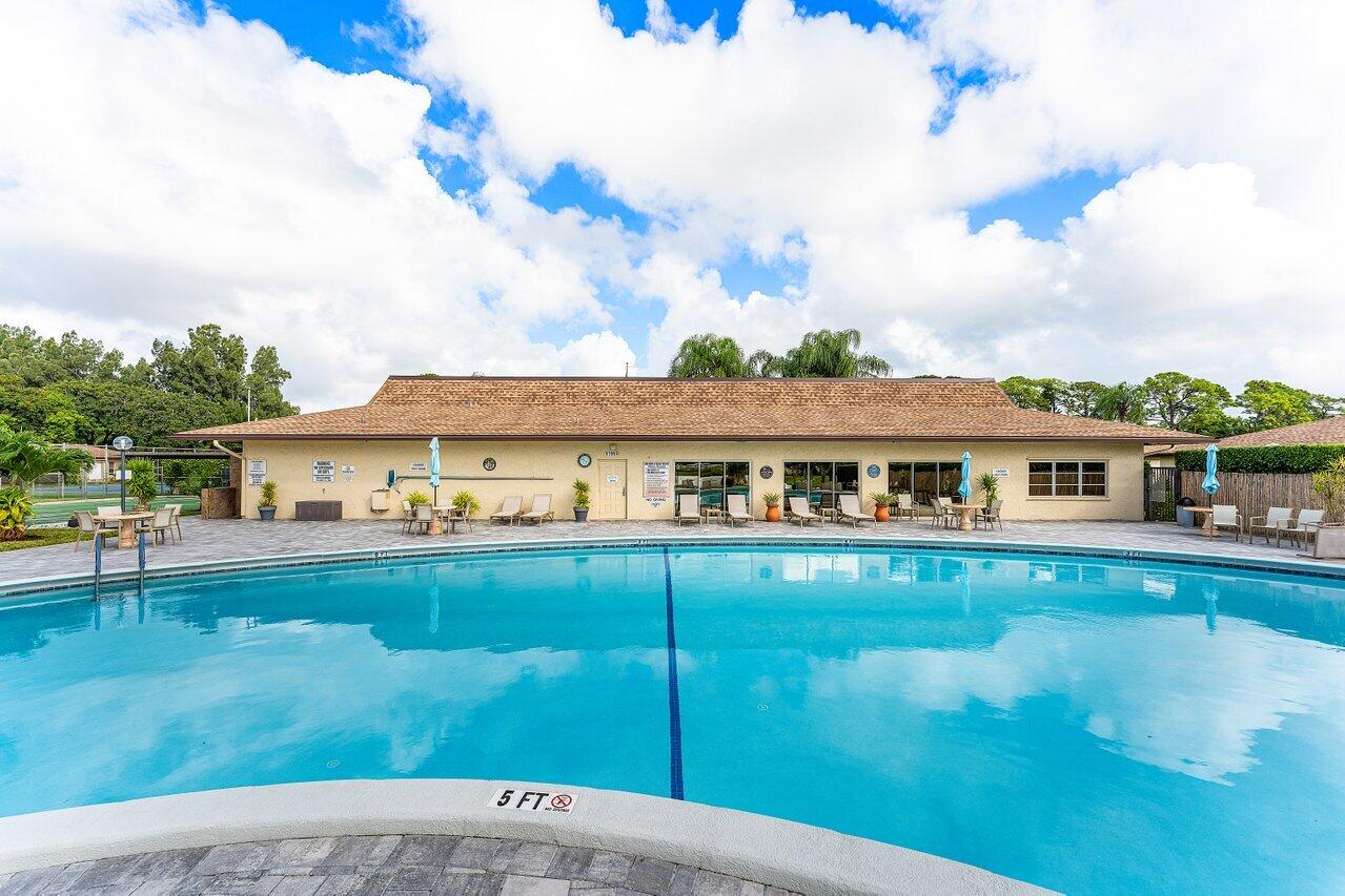 5300 Nesting Way, Unit A Delray Beach, FL 33484 - Photo 30 of 53 a front view of a house with garden