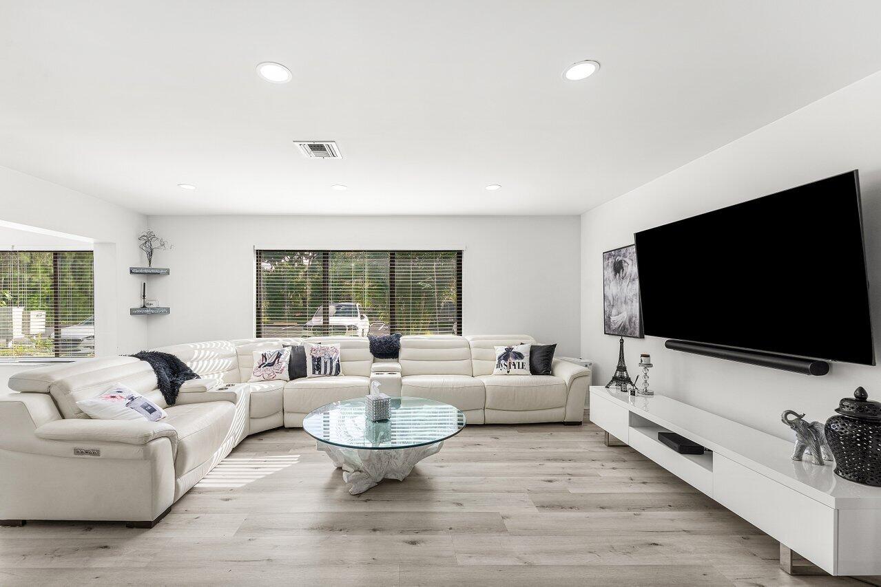 5300 Nesting Way, Unit A Delray Beach, FL 33484 - Photo 3 of 53 a living room with furniture and a flat screen tv