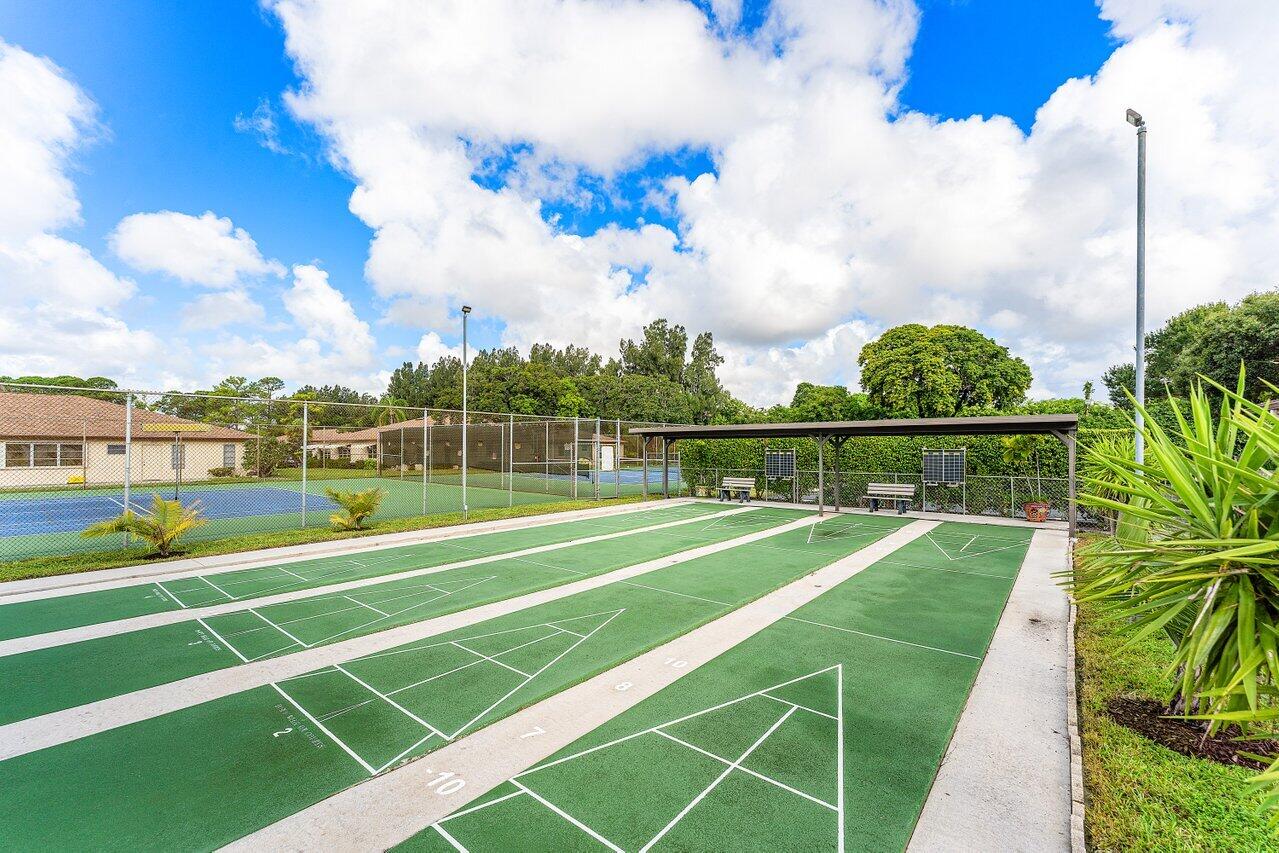 5300 Nesting Way, Unit A Delray Beach, FL 33484 - Photo 34 of 53 a view of an outdoor space and tennis court