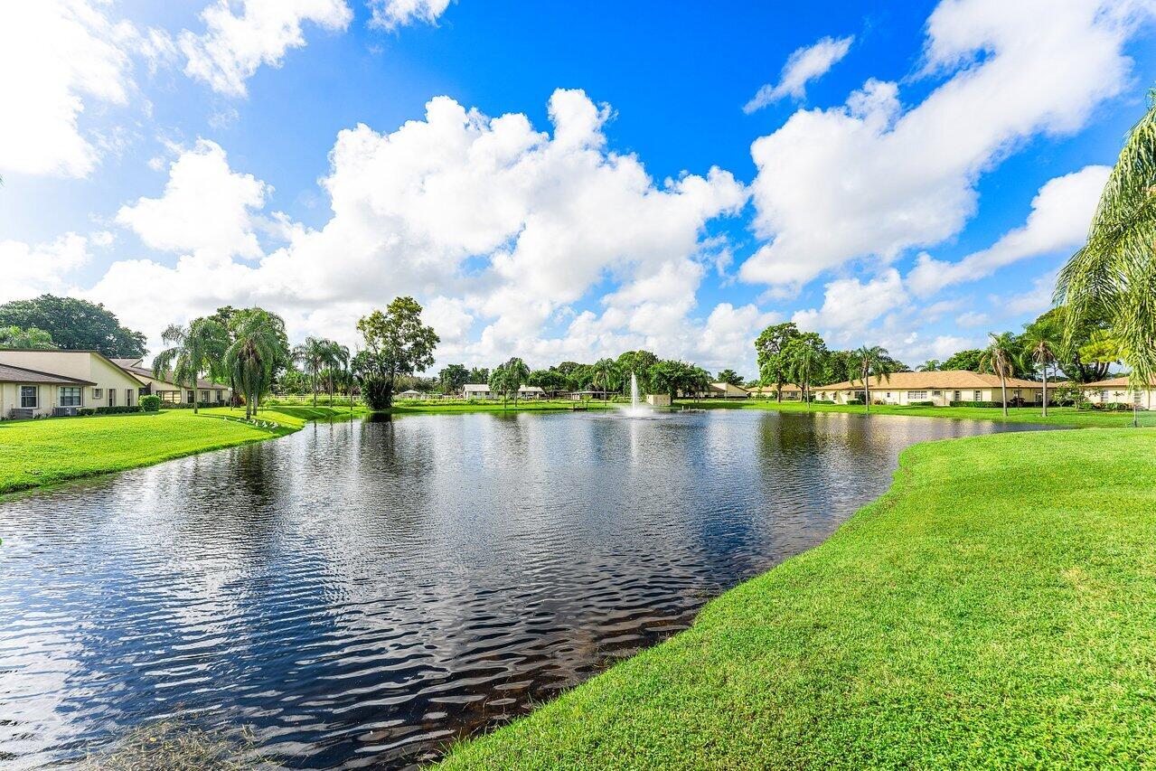 5300 Nesting Way, Unit A Delray Beach, FL 33484 - Photo 37 of 53 a view of a lake with houses in the back