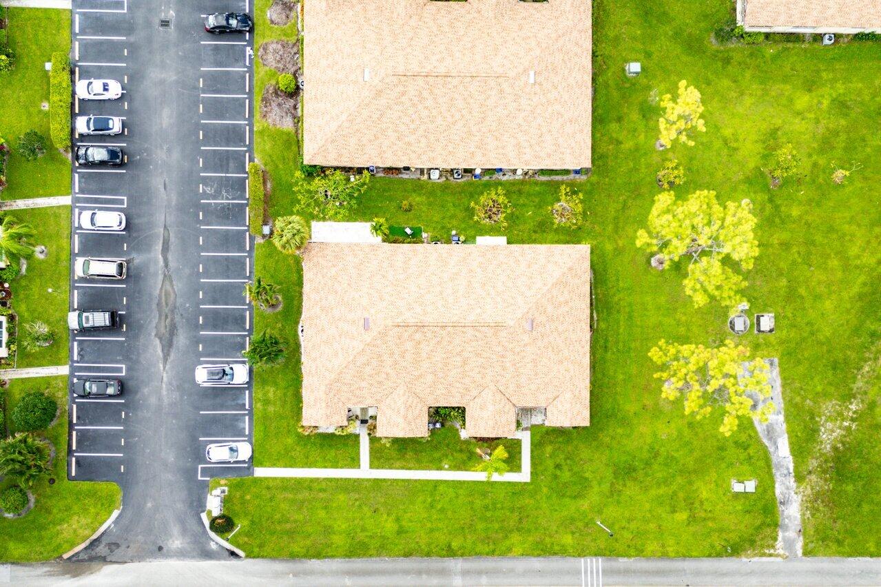 5300 Nesting Way, Unit A Delray Beach, FL 33484 - Photo 45 of 53 a view of a fountain in front of a building with a big yard