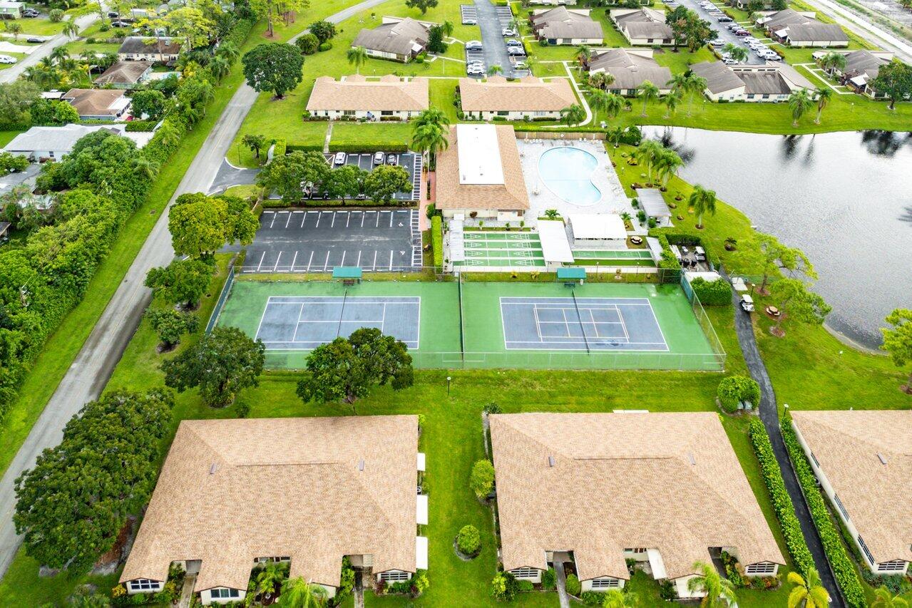5300 Nesting Way, Unit A Delray Beach, FL 33484 - Photo 48 of 53 a view of a yard with plants and large trees