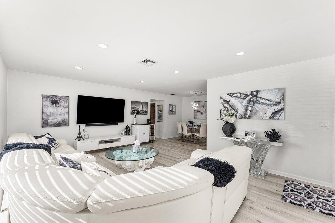 5300 Nesting Way, Unit A Delray Beach, FL 33484 - Photo 5 of 53 a bedroom with a bed and a flat screen tv