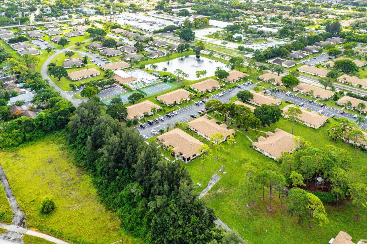 5300 Nesting Way, Unit A Delray Beach, FL 33484 - Photo 51 of 53 a view of a yard with swimming pool