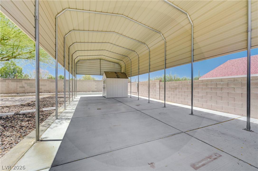 7631 Bermuda Road Las Vegas, NV 89123 - Photo 36 of 64 A spacious covered carport, perfect for multiple vehicles or outdoor activities, includes a practical storage shed.
