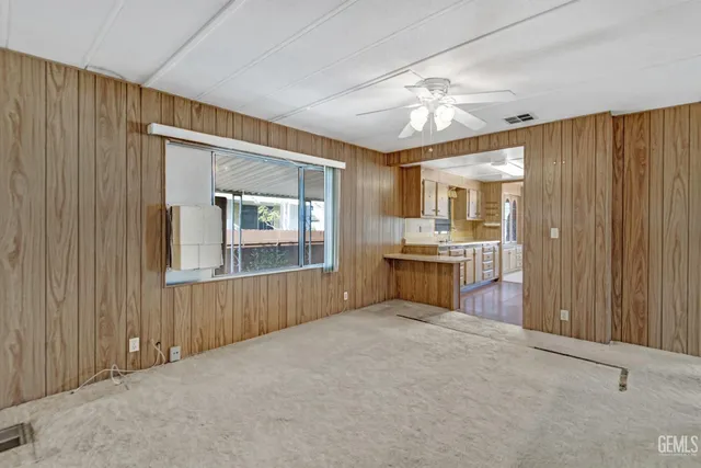 a kitchen with granite countertop a sink stove and cabinets