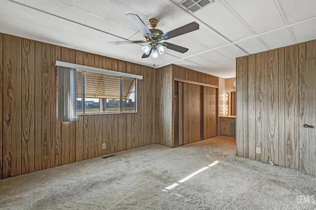 a bathroom with a granite countertop sink a mirror and shower