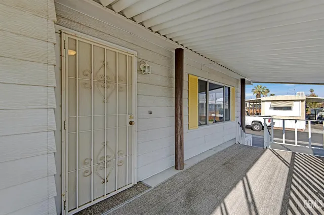 a view of a hallway with wooden floor and stairs