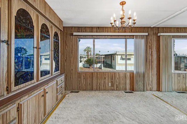 an empty room with fan and windows