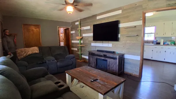 a living room with furniture and a flat screen tv