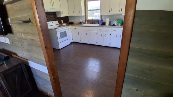 a kitchen with stainless steel appliances a sink a stove a refrigerator a sink a counter top space and cabinets