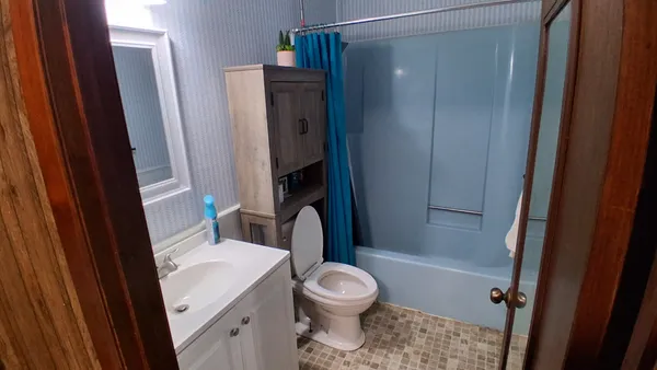 a white toilet sitting next to a bathroom sink