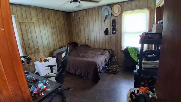 a bedroom with a bed and a window