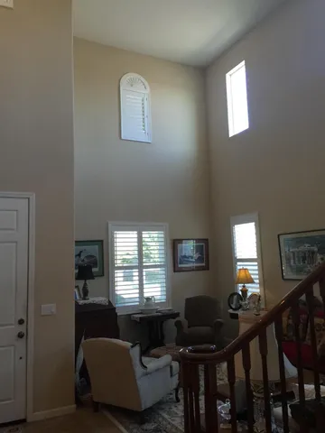 a living room with furniture and a lamp