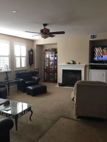 a living room with furniture and a fireplace