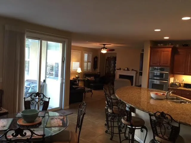 a dining table with chairs and window