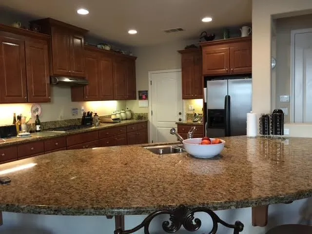 a kitchen with stainless steel appliances granite countertop wooden cabinets a sink and dishwasher