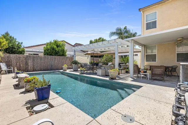 a building outdoor space with patio furniture and potted plants