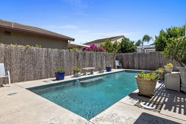 a view of a backyard with swimming pool