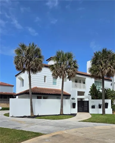 a view of a house with a yard and tree s