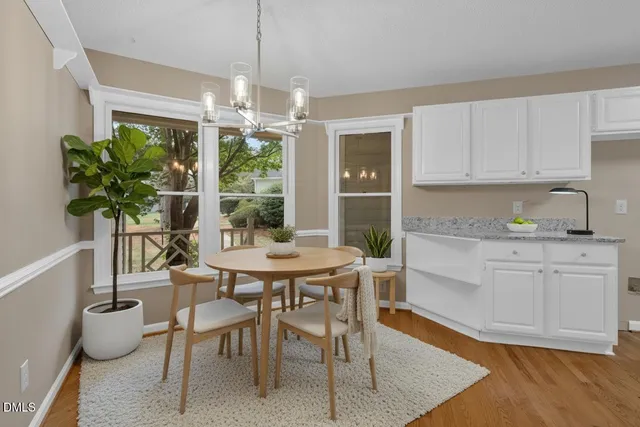 a spacious bedroom with a large bed and a chandelier