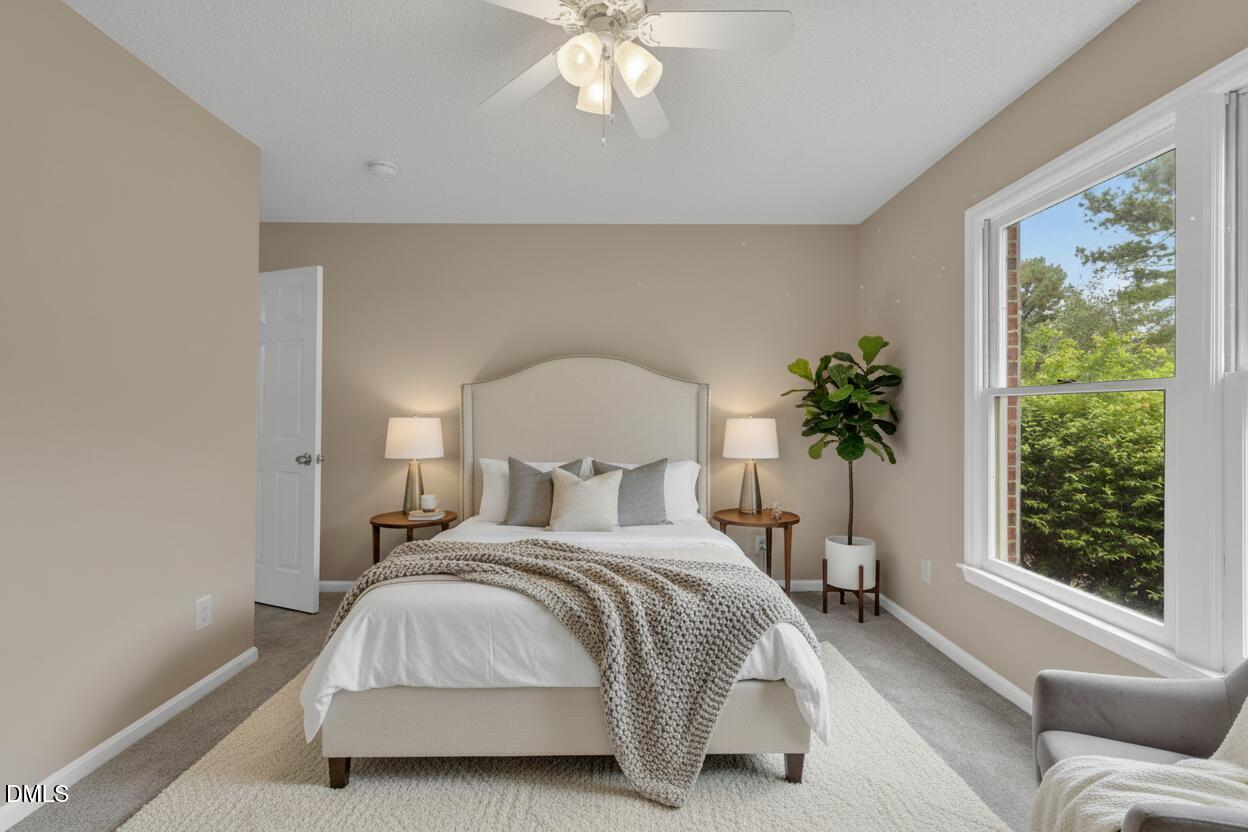 42 Renwick Court Raleigh, NC 27615 - Photo 28 of 58 a bedroom with a large bed and a large window