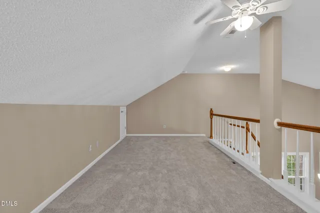 a view of a hallway with wooden floor and windows