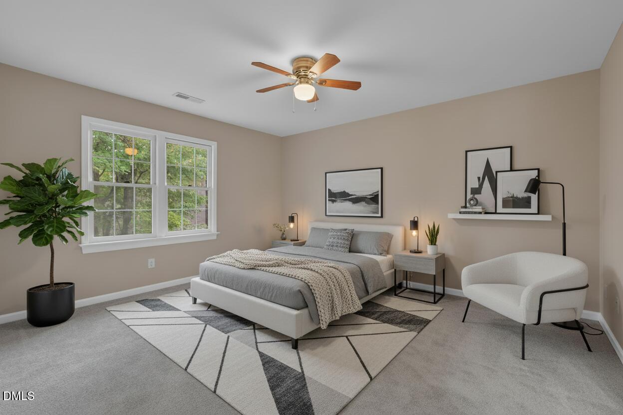 42 Renwick Court Raleigh, NC 27615 - Photo 37 of 58 a spacious bedroom with a bed a chandelier and a window