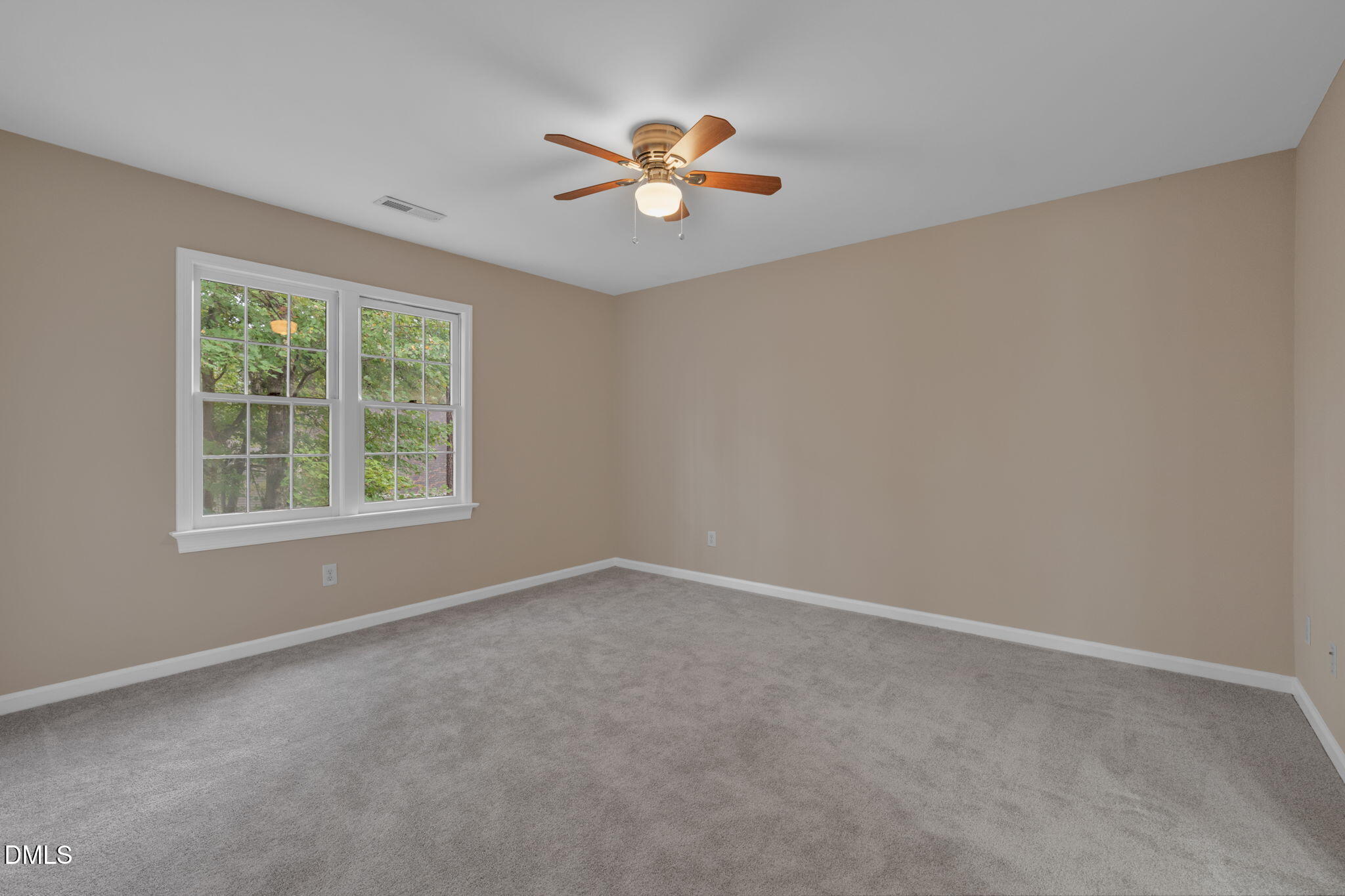42 Renwick Court Raleigh, NC 27615 - Photo 38 of 58 an empty room with a window and a fan
