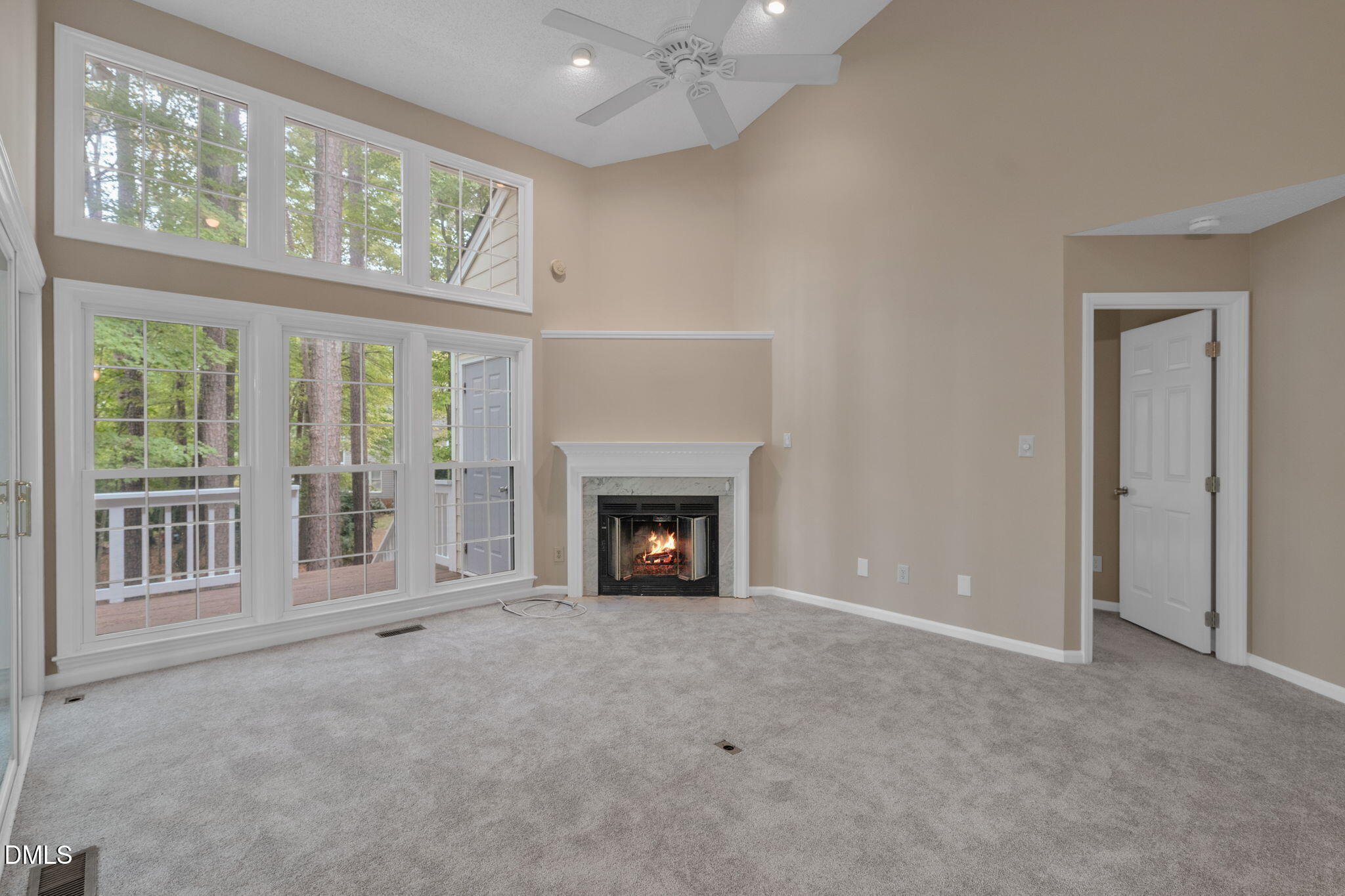 42 Renwick Court Raleigh, NC 27615 - Photo 4 of 58 a view of an empty room with a window and fireplace