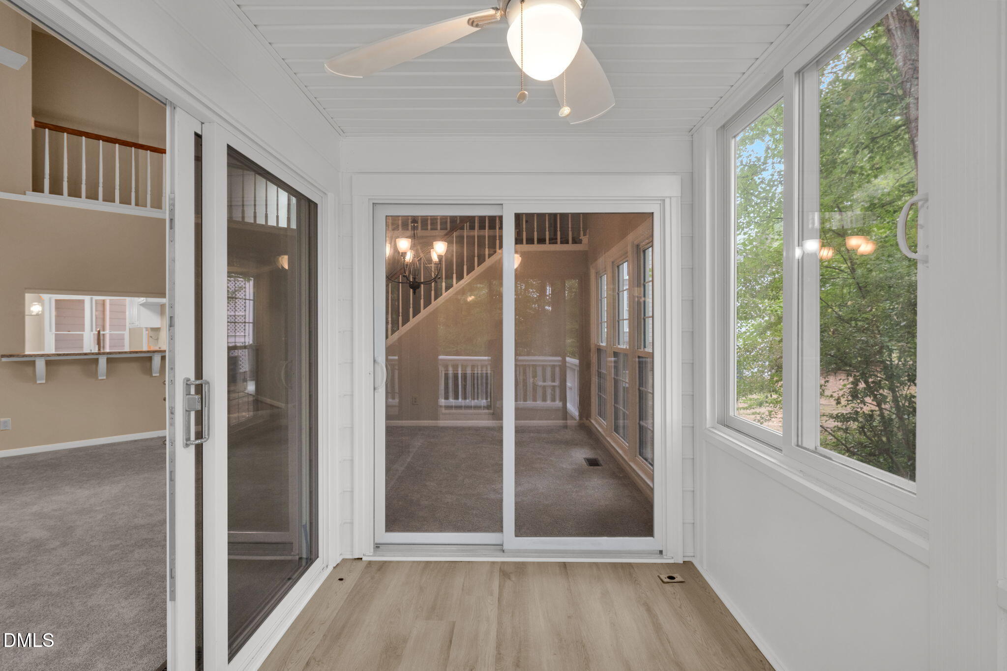 42 Renwick Court Raleigh, NC 27615 - Photo 43 of 58 a view of a hallway with wooden floor and windows