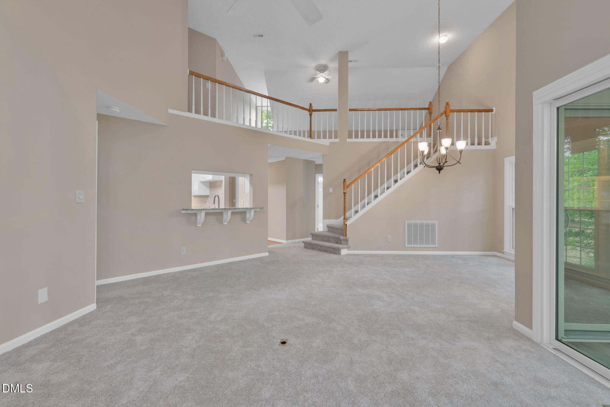 42 Renwick Court Raleigh, NC 27615 - Photo 5 of 58 a view of an empty room with stairs and a way to kitchen
