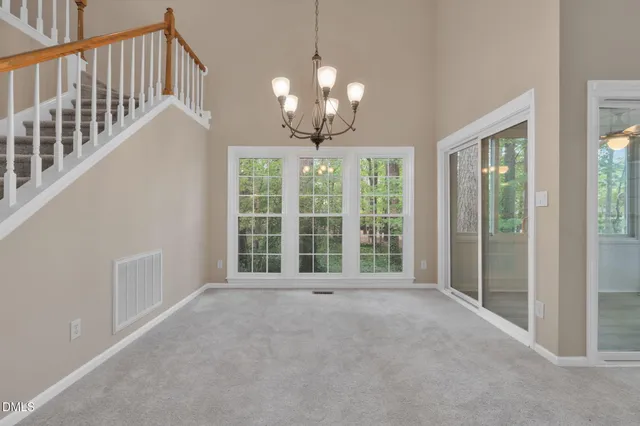 a kitchen with granite countertop white cabinets and a wooden floor