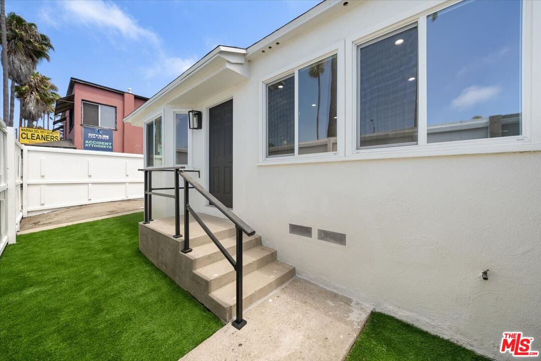 a view of house with backyard and outdoor seating