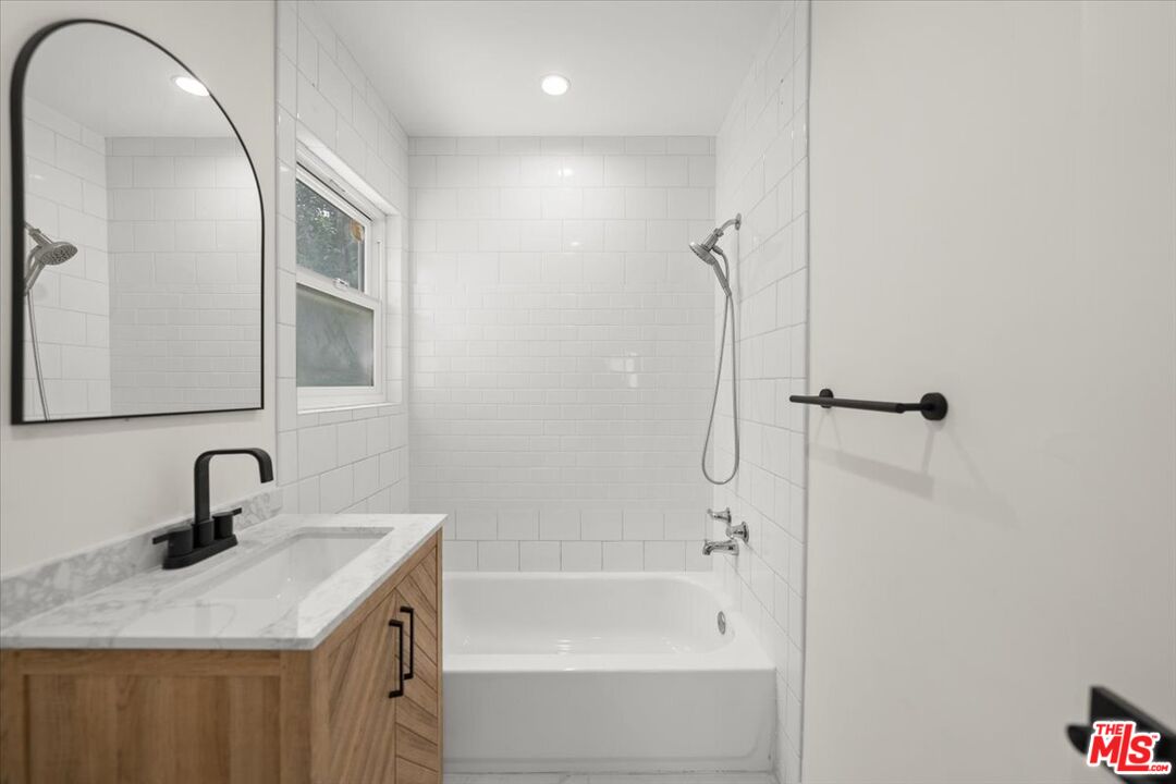 702 Washington Boulevard Marina del Rey, CA 90292 - Photo 14 of 18 a bathroom with a sink and mirror with bathtub