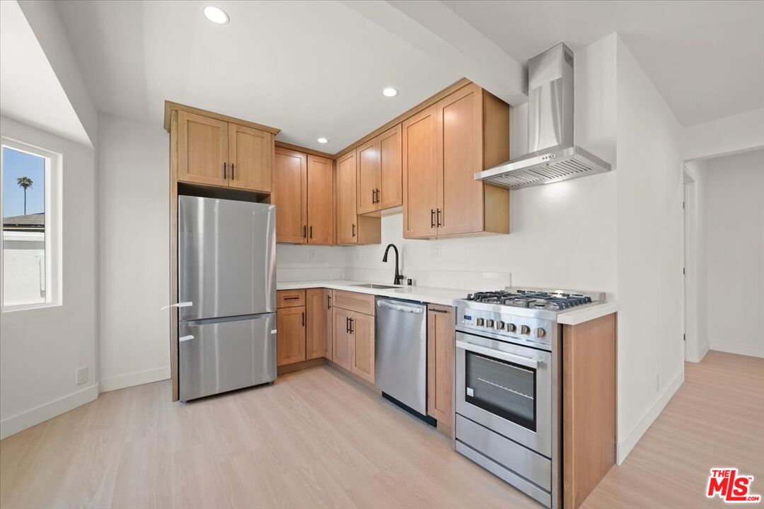 702 Washington Boulevard Marina del Rey, CA 90292 - Photo 7 of 18 a kitchen with stainless steel appliances granite countertop a stove a refrigerator and a refrigerator